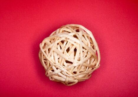 A ball of twine on a red background.