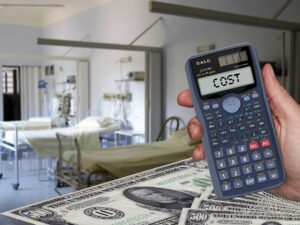 A calculator with money and a hospital room in the background.