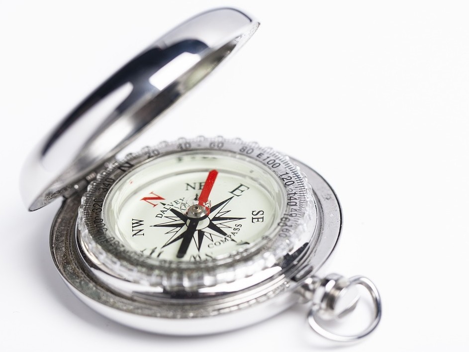 A silver compass shown open.